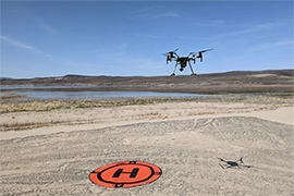 drone taking flight over lake